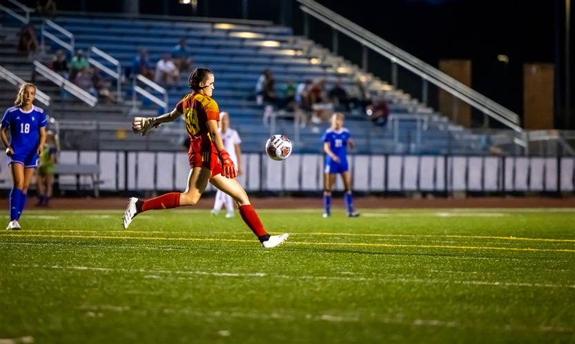A goalkeeper prepares to kick the ball